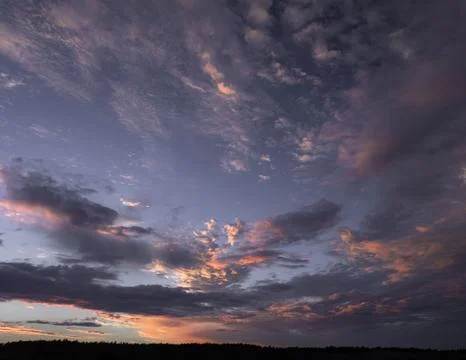 Dramatic Pastel Clouds Over a Serene Sunset Stock Photos