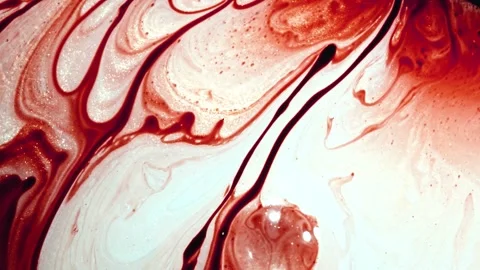 Dramatic patterns form with red and white liquid colors moving gently Stock Footage 327575651