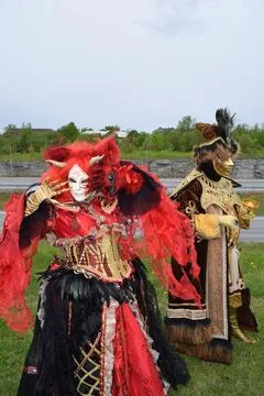 Dramatic Performance in Ornate Red Horned Mask for Fantasy Fashion Festival. Stock Photos
