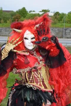 Dramatic Performance in Ornate Red Horned Mask for Fantasy Fashion Festival. Stock Photos