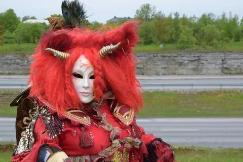 Dramatic Performance in Ornate Red Horned Mask for Fantasy Fashion Festival. Stock Photos