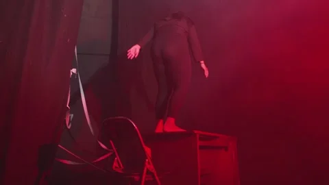 Dramatic Performance in Red Lighting Stock Footage 296545048