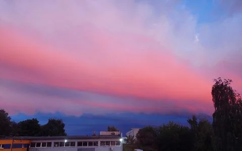 Dramatic Pink and Blue Sunset Sky over City Buildings Stock Photos