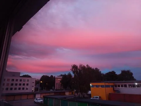 Dramatic Pink and Blue Sunset Sky over City Buildings Stock Photos