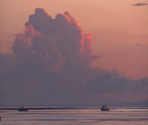 Dramatic pink and purple clouds over WS boat moored in still water Stock Footage 86747634