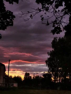 Dramatic pink and purple sunset before a thunderstorm Stock Photos