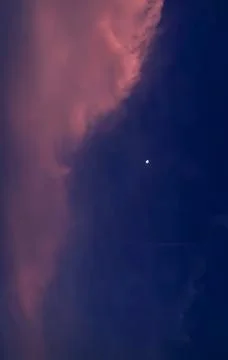 Dramatic Pink Clouds and Bright Star in Deep Blue Twilight Sky Stock Photos
