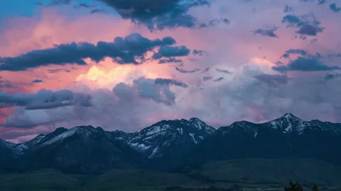 Dramatic pink clouds evolving over mountain range at sunset Stock Footage 167110228