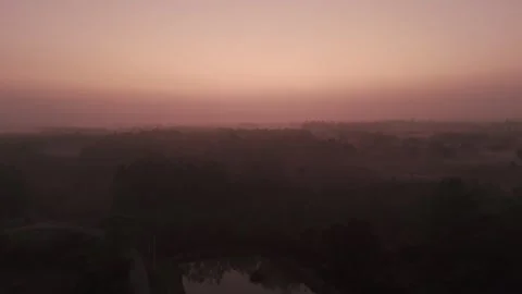 Dramatic pinkish sky during sunrise. Drone view. Hazy skyscape. Stock Footage 301038628
