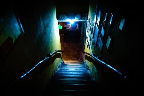 Dramatic point of view of scary stairs from upside into darkness of interior of Stock Photos
