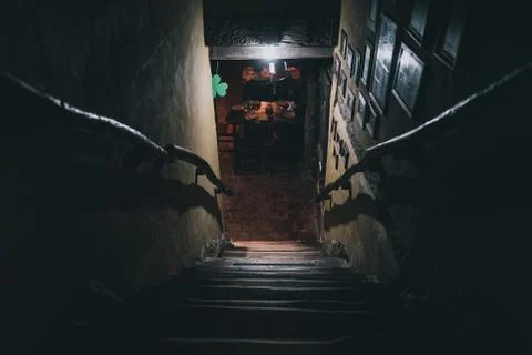 Dramatic point of view of scary stairs from upside into darkness of interior of Stock Photos