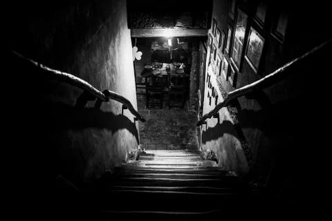 Dramatic point of view of scary stairs from upside into darkness of interior of Stock Photos