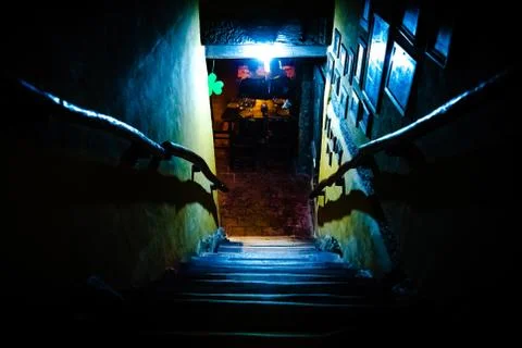 Dramatic point of view of scary stairs from upside into darkness of interior of Stock Photos