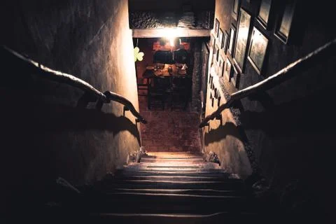 Dramatic point of view of scary stairs from upside into darkness of interior of Stock Photos