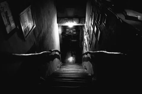 Dramatic point of view of stairs from upside into darkness of interior of old Stock Photos