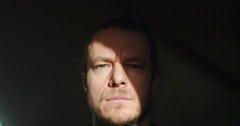 Dramatic portrait of bearded man opening eyes on black background copy space Stock Footage 151093430