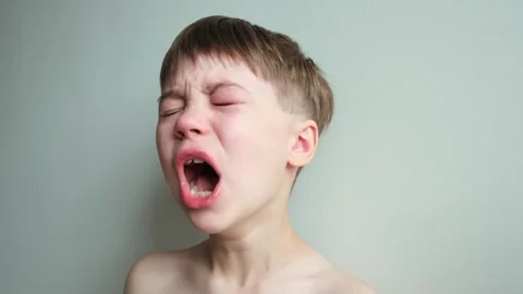 Dramatic portrait of a crying 7 year old... | Stock Video | Pond5