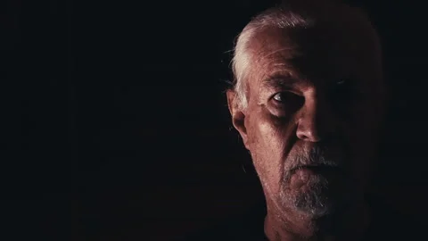 Dramatic Portrait of Elderly Man in Darkness Stock Footage 324609000