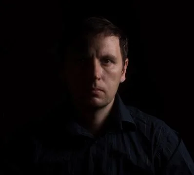 Dramatic portrait of a man in a low key. People Stock Photos