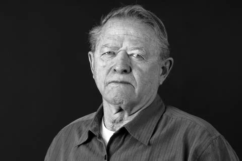 Dramatic portrait of sad old man Stock Photos