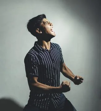 Dramatic portrait side shot of a good looking handsome man in half shirt is w Stock Photos