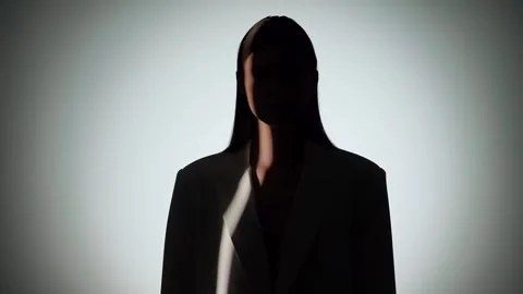 Dramatic Portrait of Woman in Shadow and Light Beam Stock Footage 310498317