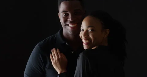 Dramatic portrait of young Black couple holding each other smiling Video stock 42657754