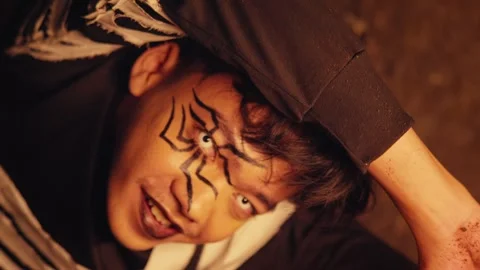 Dramatic Portrait of a Young Man with Tiger Face Paint Stock Footage 296680599