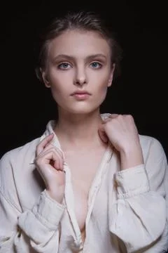 Dramatic portrait of a young seductive beautiful brunette girl with short hai Stock Photos