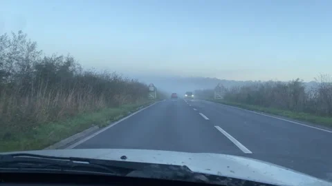 Dramatic POV  Driving Shot in the UK along rural roads in the morning fog Stock Footage 289105071