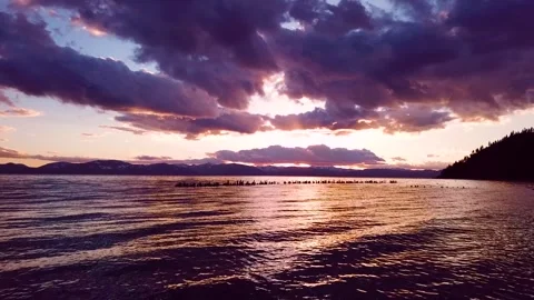 Dramatic purple and orange sunset over tranquil lake tahoe with distant mou.. Stock Footage 337751794