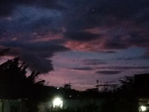 Dramatic Purple Pink Night Sky Over Dark Silhouetted Landscape Stock Photos