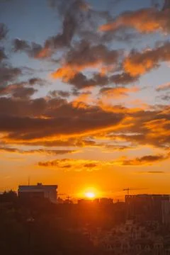 Dramatic purple sunset with orange clouds Stock Photos