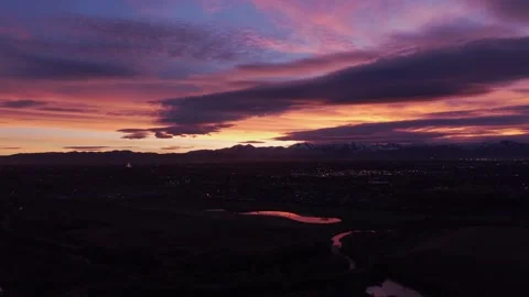 Dramatic purple sunset over mountains and city in Midvale, Utah, USA Stock Footage 333880140