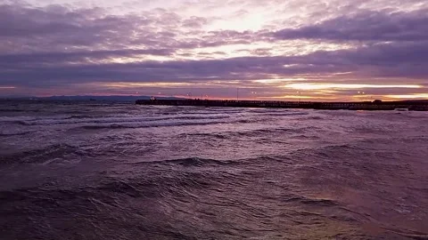 Dramatic Purple Sunset over Wavy Sea and Pier in Sarkoy Turkey 스톡 동영상 332081059