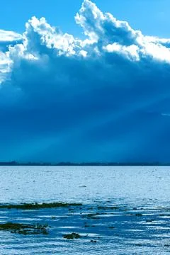 Dramatic rain clouds covers the lake and mountains. Stock Photos