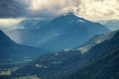 Dramatic rain clouds in the mountain valley. Stock Photos