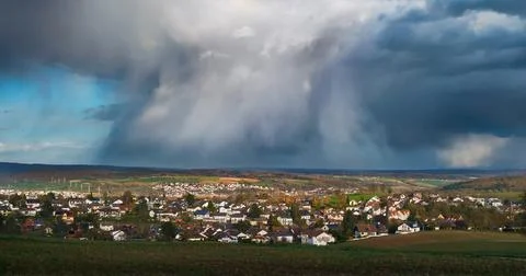 Dramatic rain clouds over a scenic village Stock Photos