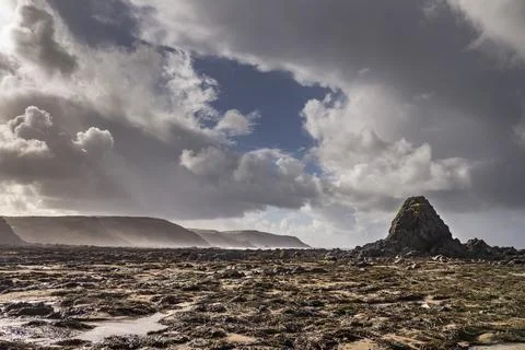 Dramatic rain clouds over Widemouth Bay beach Cornwall Stock Photos