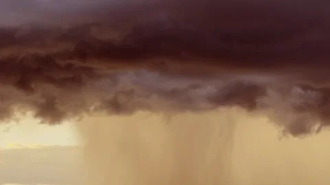 Dramatic rain storm downpour right before sunset against a golden sky Video stock 335848412