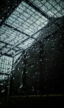 Dramatic Rain Water Droplet on window under the dark skies Stock Photos