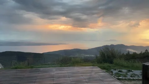 Dramatic Rainy Sunset Over Aegean Mountains from Wooden Terrace, Mugla Turkey Stock Footage 333523526