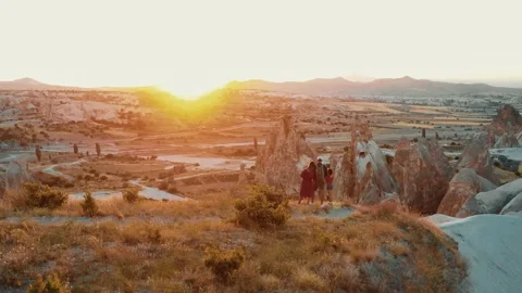 Dramatic rear view aerial shot, happy tourist family with children watch epic Stock Footage 171414040