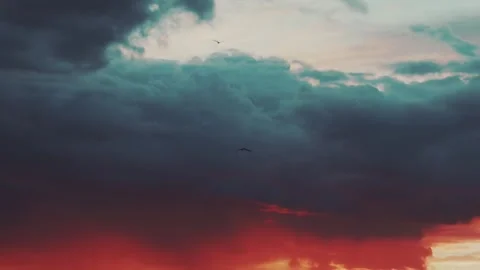 Dramatic Red and Blue-Gray Storm Clouds at Intense Sunset or Sunrise Stock Footage 320655759