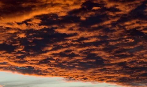 Dramatic Red clouds for pattern background. A burning sky in a horror movie.  Stock Photos