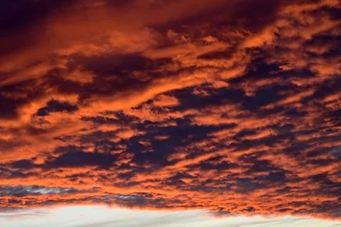 Dramatic Red clouds for pattern background. A burning sky in a horror movie.  Stock Photos