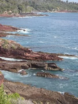 Dramatic Red Rock Coastline Stock Photos