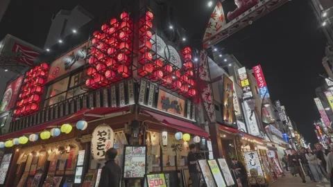 Dramatic Red Square Lantern-Covered Yakitori Restaurant Facade on Night Street Stock Footage 337035852