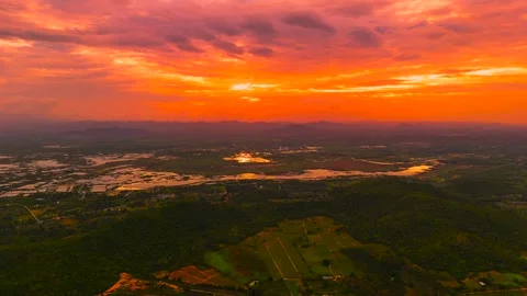Dramatic red sunset with colorful clouds and reflections in water across valley Stock Footage 320455533