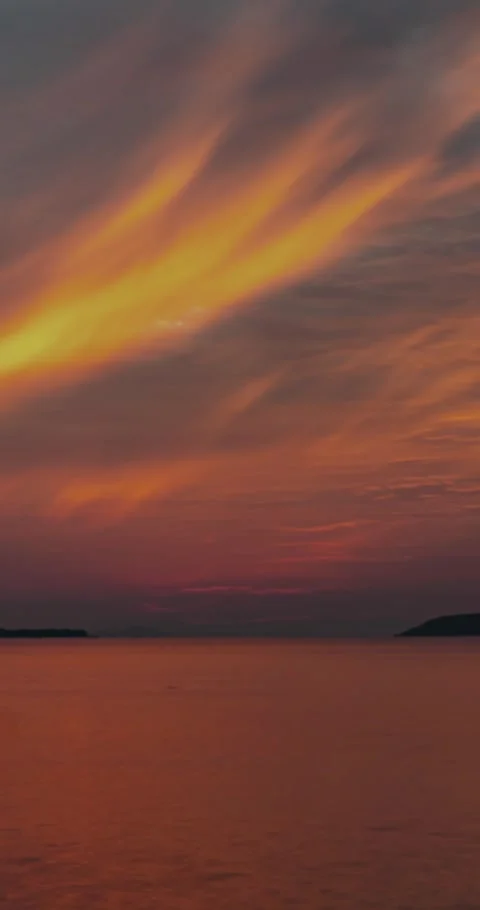 Dramatic Red Sunset Over Calm Sea with Dark Clouds Stock Footage 340609103
